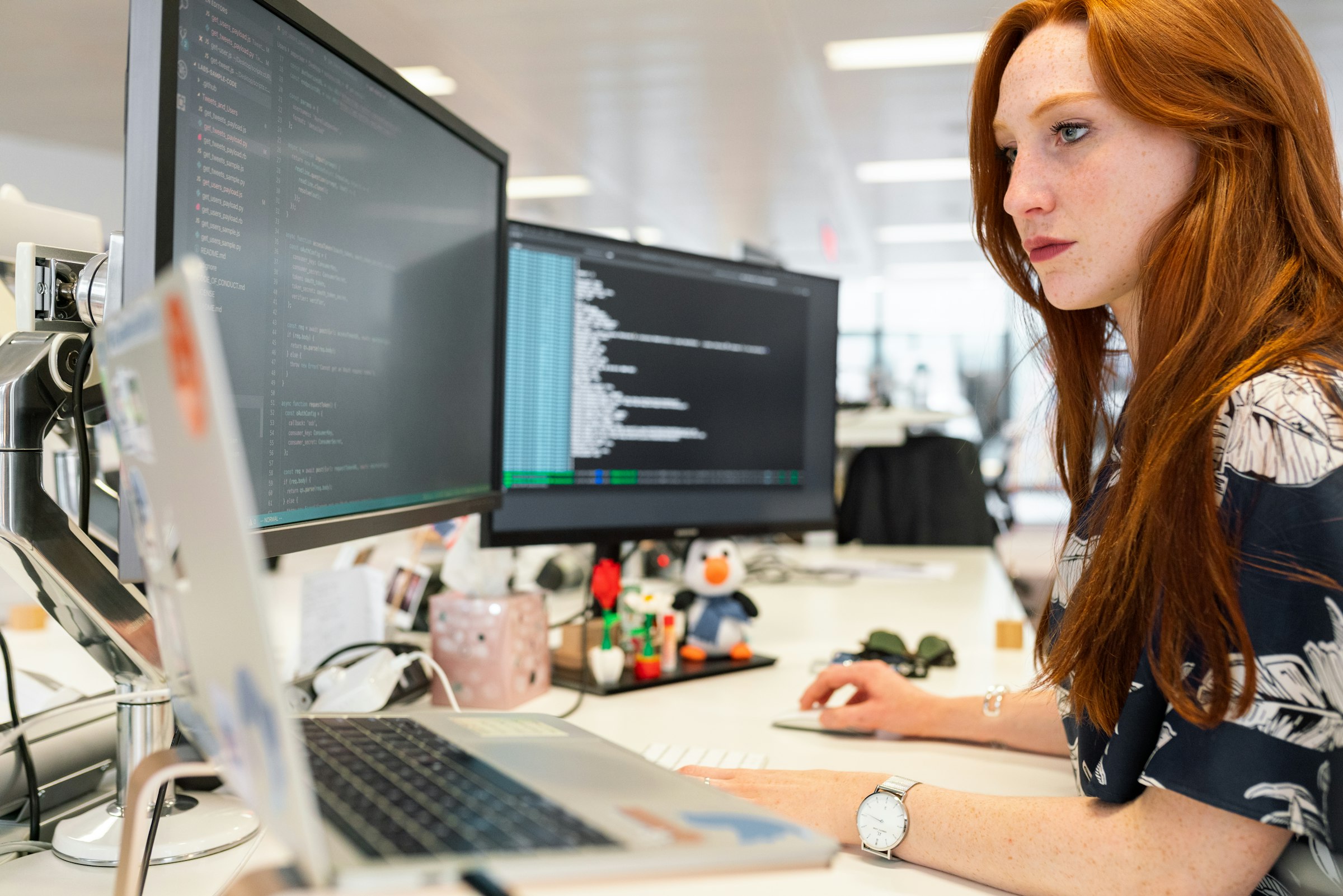 Analyst reviewing data across multiple monitors