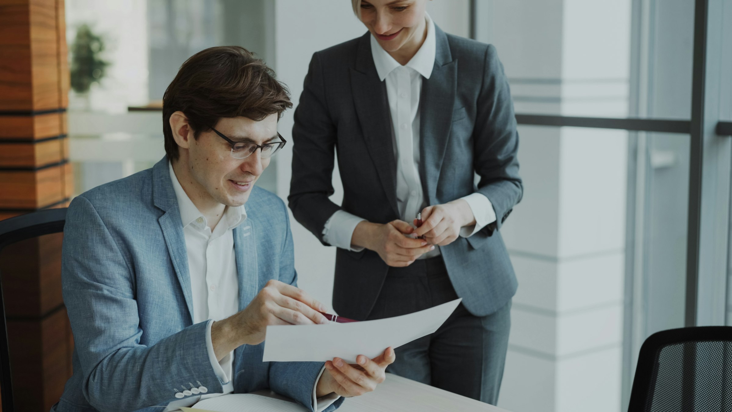 Two colleagues reviewing documents together